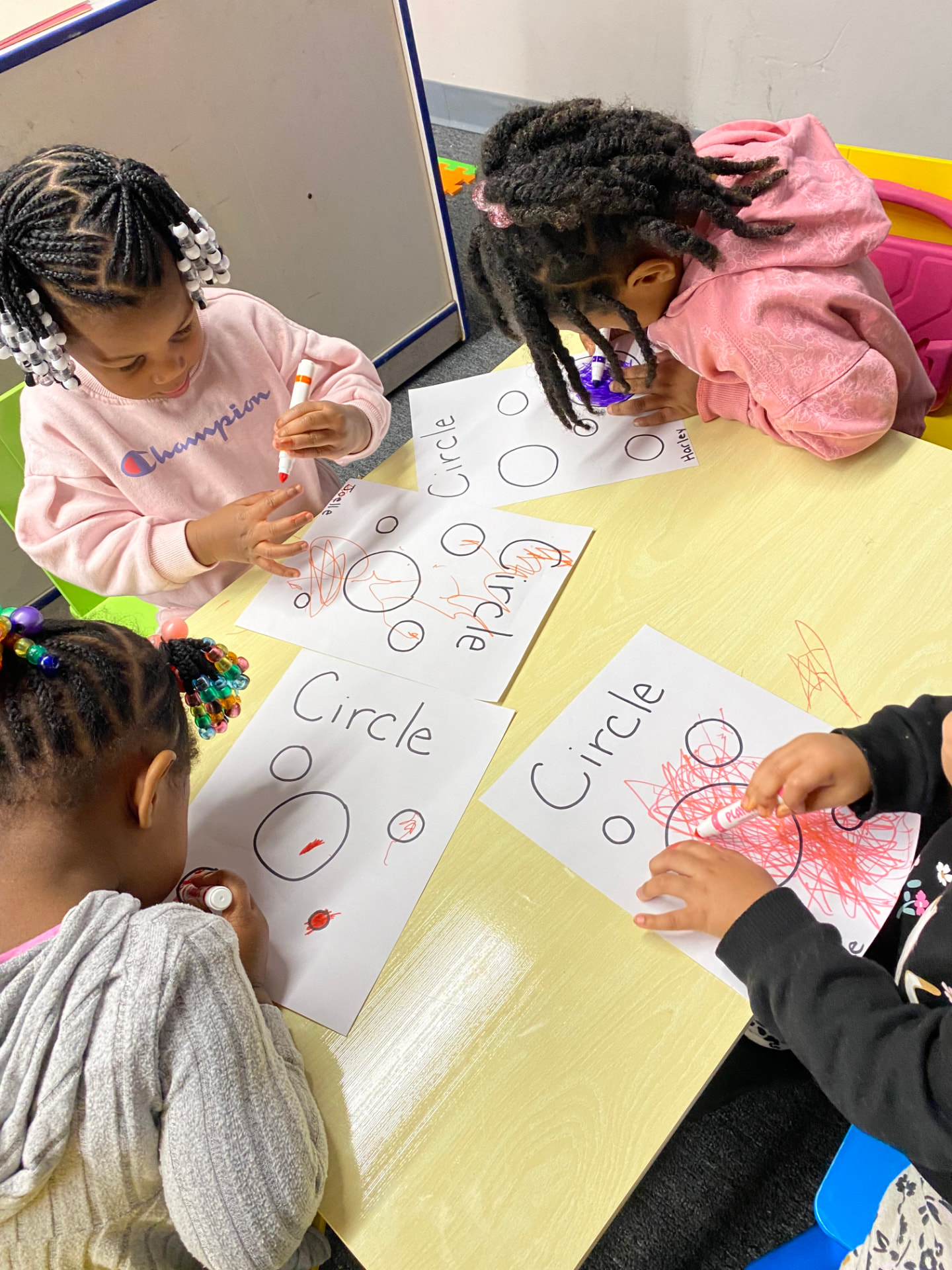 A teacher guiding children through a classroom activity